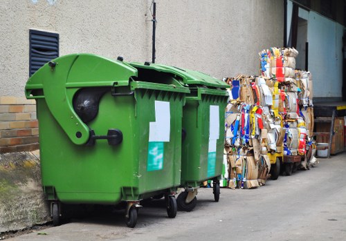 Environmentally friendly enclosed skip with recycling symbol in Kingston